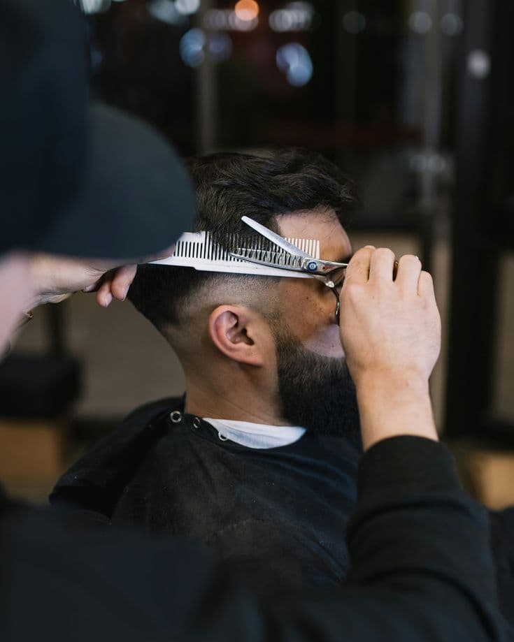 Barber styling a client